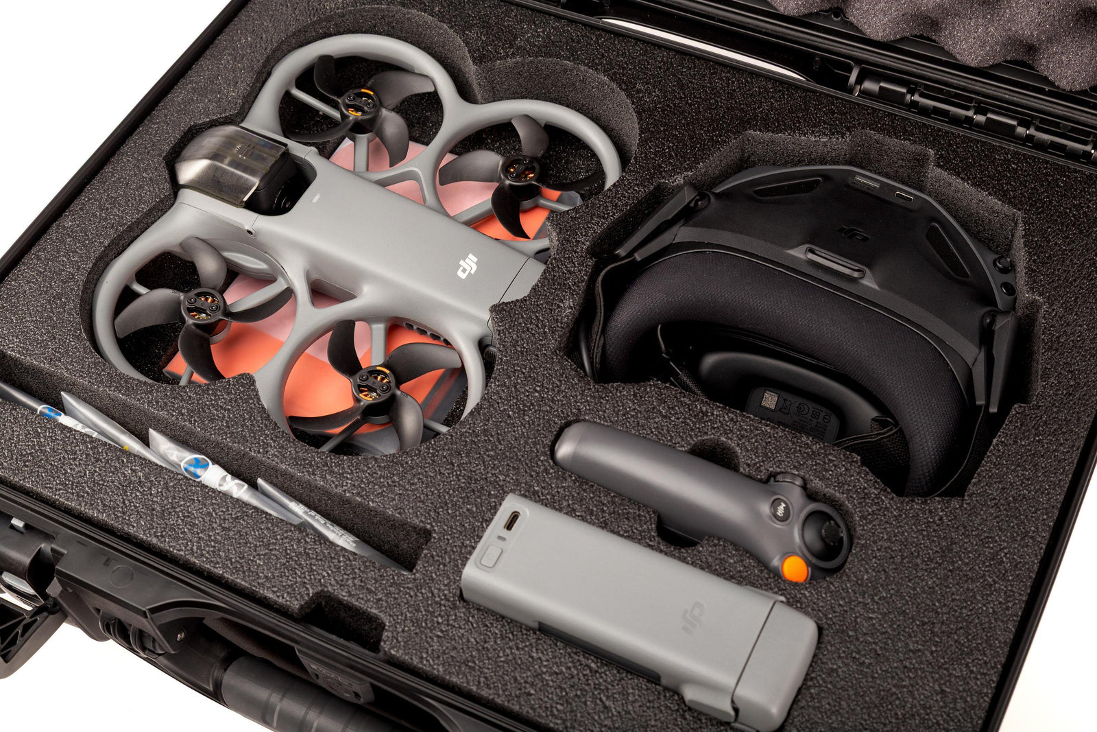 Two drones and a case with foam padding on a white background