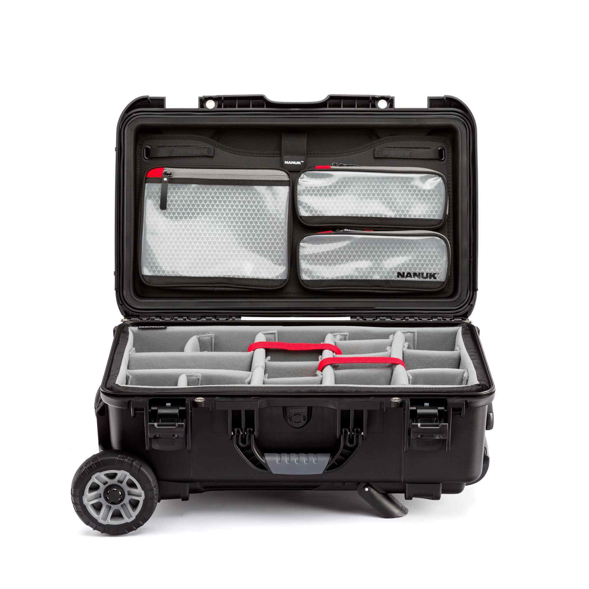 Black hard-shell travel case with compartments and wheels on a white background Black hard-shell travel case with compartments and wheels on a white background