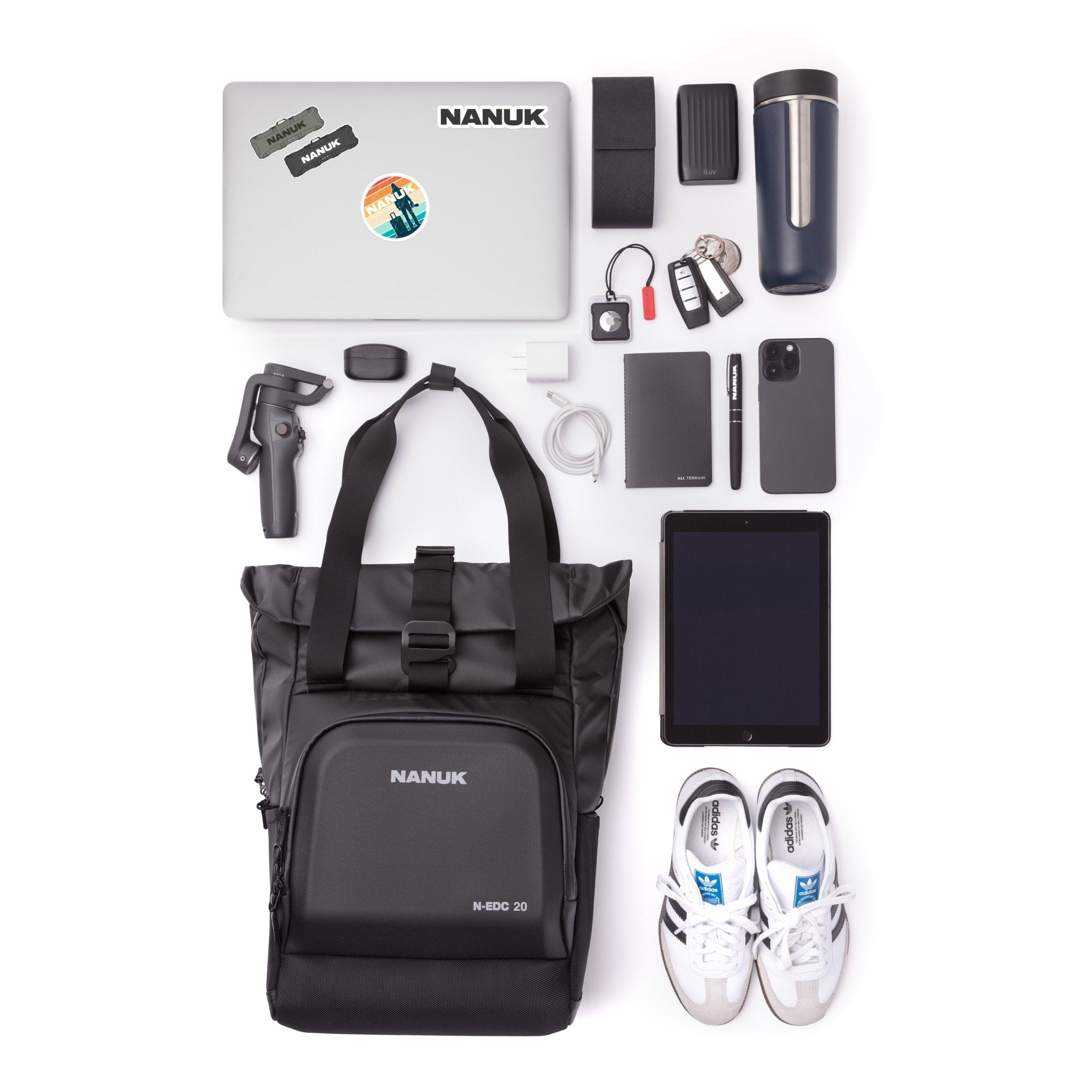 Collection of travel items including a laptop, backpack, shoes, and electronic devices on a white background. Collection of travel items including a laptop, backpack, shoes, and electronic devices on a white background.
