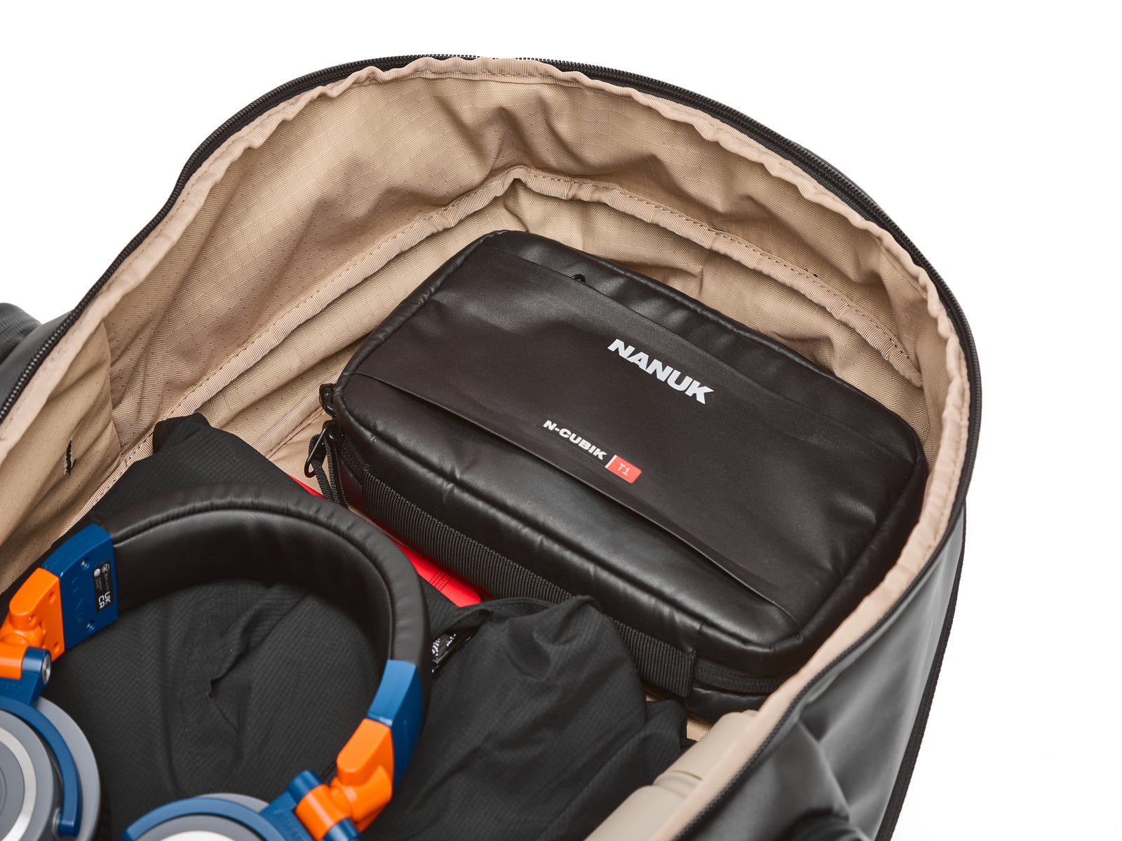 Nanuk carrying case inside a larger bag with headphones visible