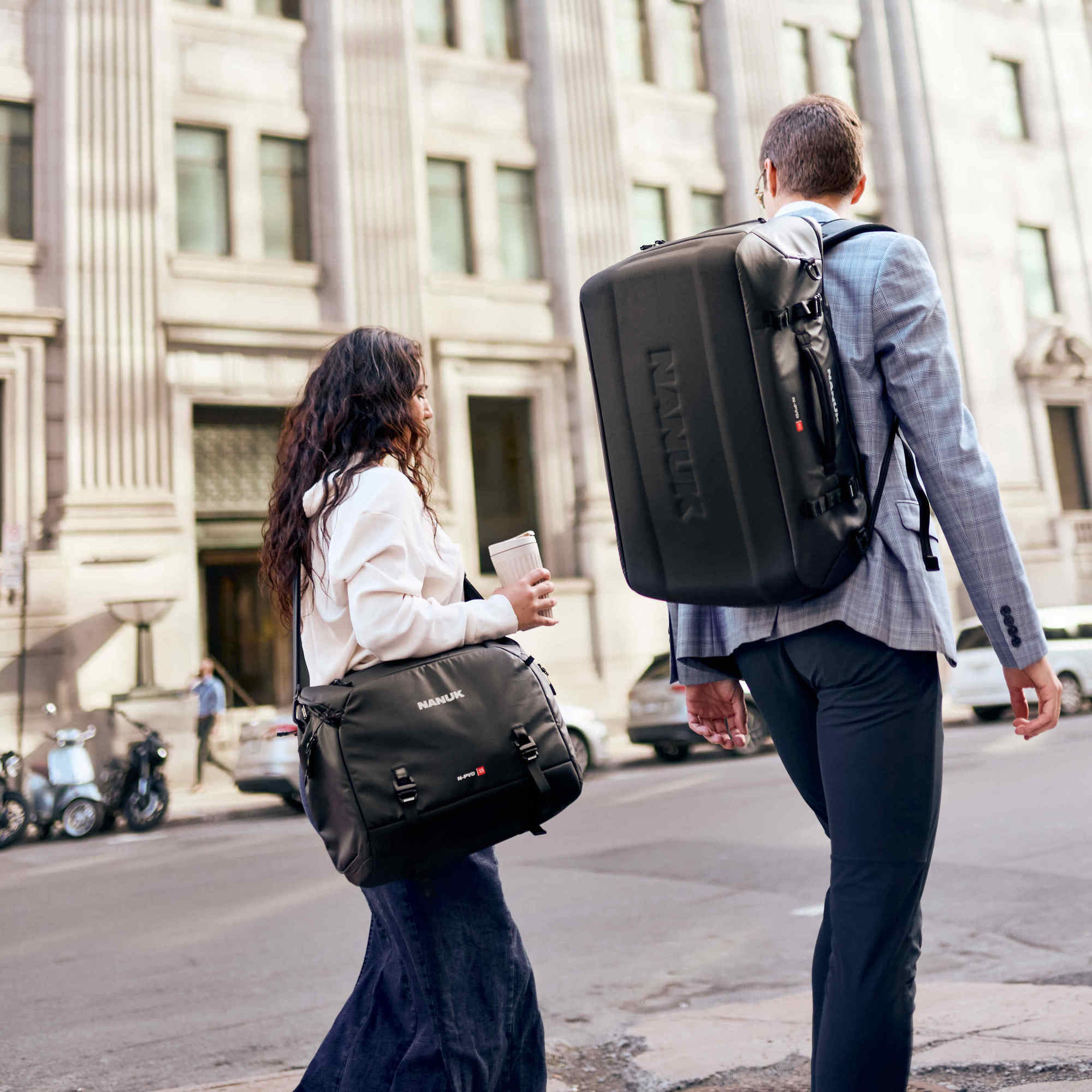 Two Photographers walking with a N-PVD 15L Messenger Bag and a _N-PVD 40L Duffle_Bag in the city