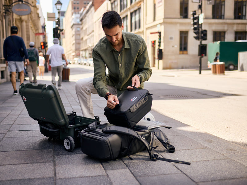 Photographer switching N-Cubik 13L from Nanuk 935 to Nanuk Backpack