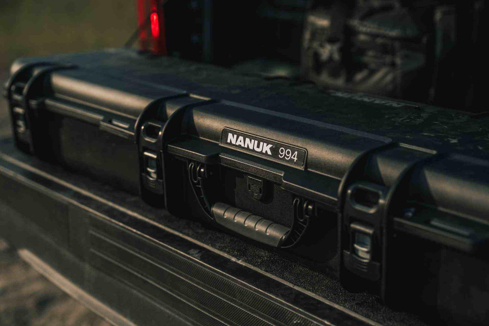Black NANUK 994 hard-shell case attached to a vehicle's bed.