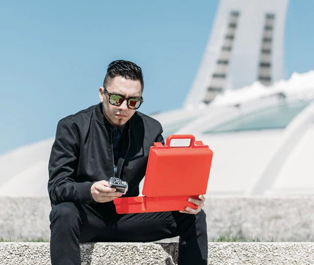 Photograph holding a red Clickcase in the city