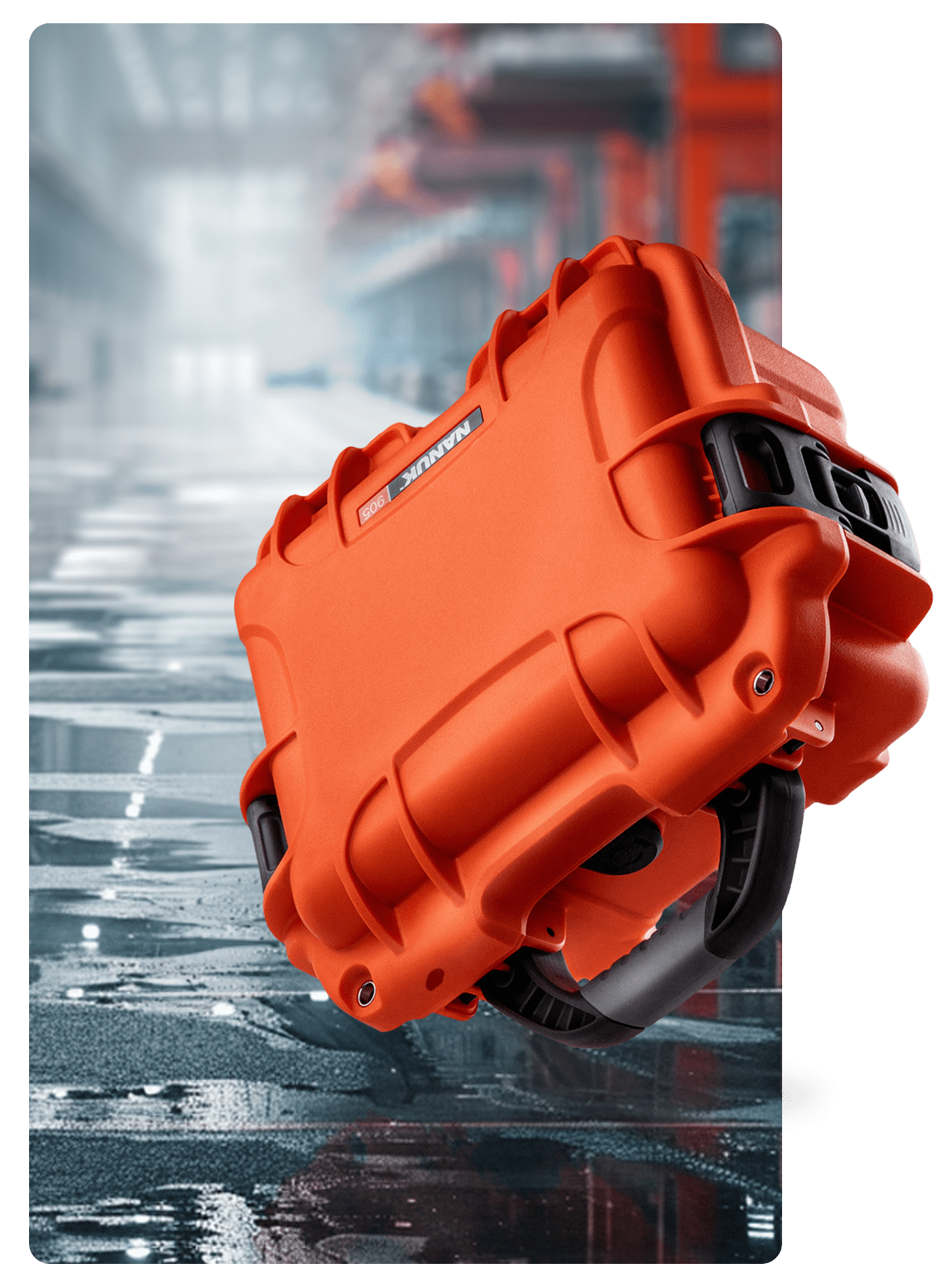Nanuk 905 Orange case falling on the ground in a warehouse.