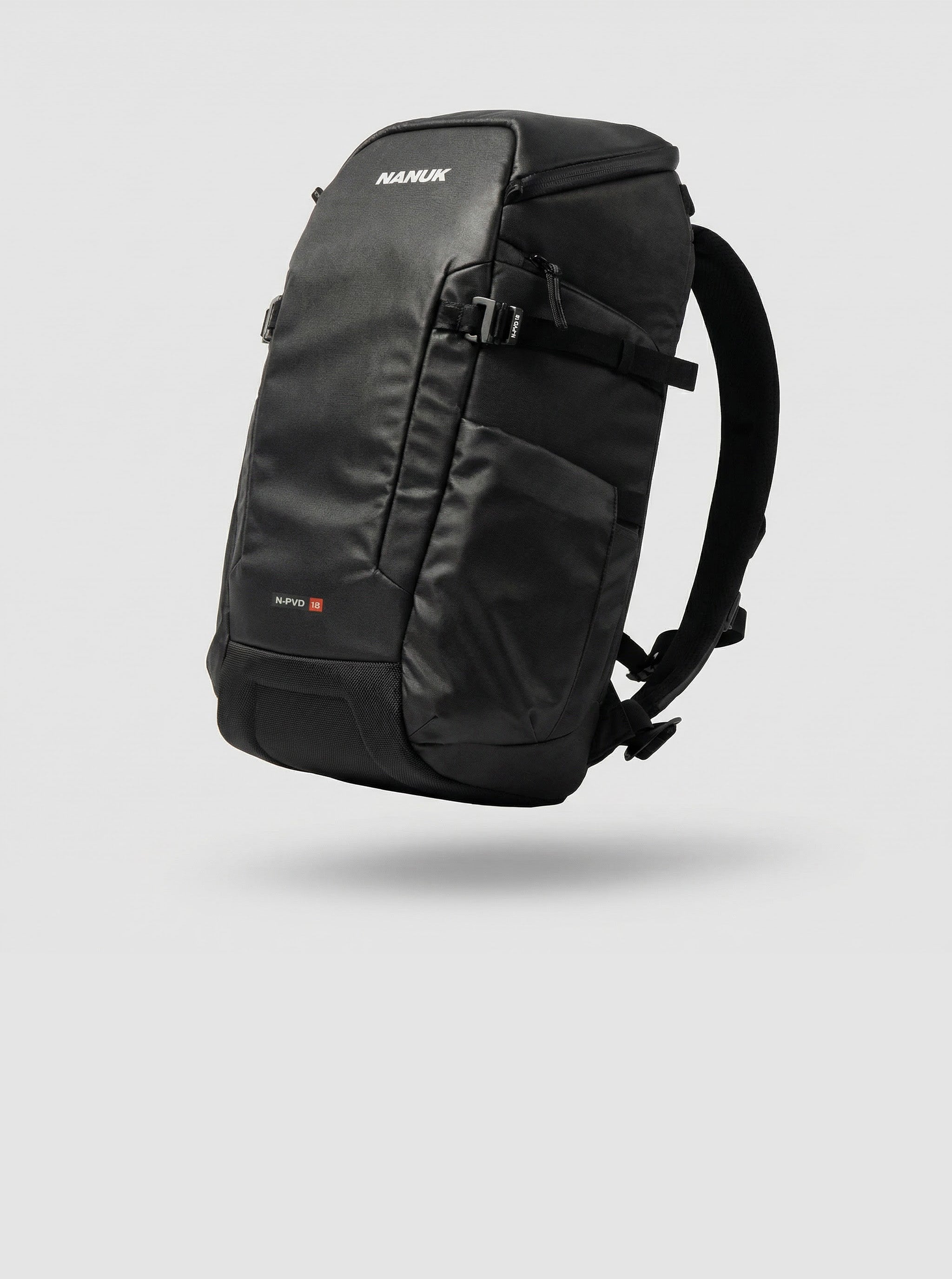 A sleek black Nanuk backpack, part of the nanuk bags and cases collection, is displayed hovering against a clean, light grey background.