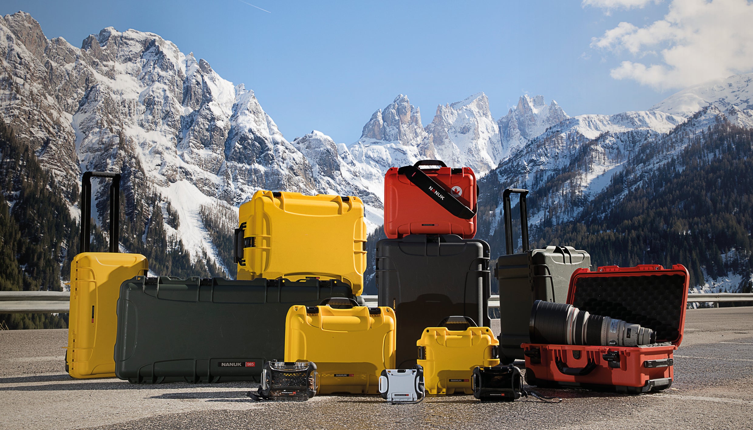 Nanuk cases of various sizes in front of Rocky Mountains