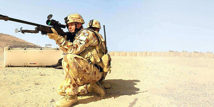 Military in service with a Nanuk long case Tan