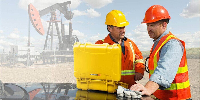 Workers in a mine with a yellow Nanuk case