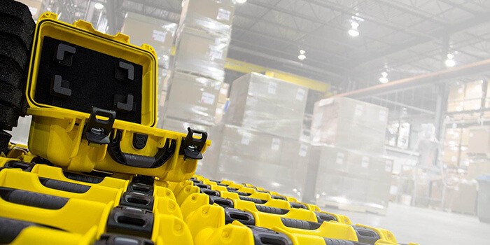 Yellow Nanuk cases with custom foam insert in a warehouse