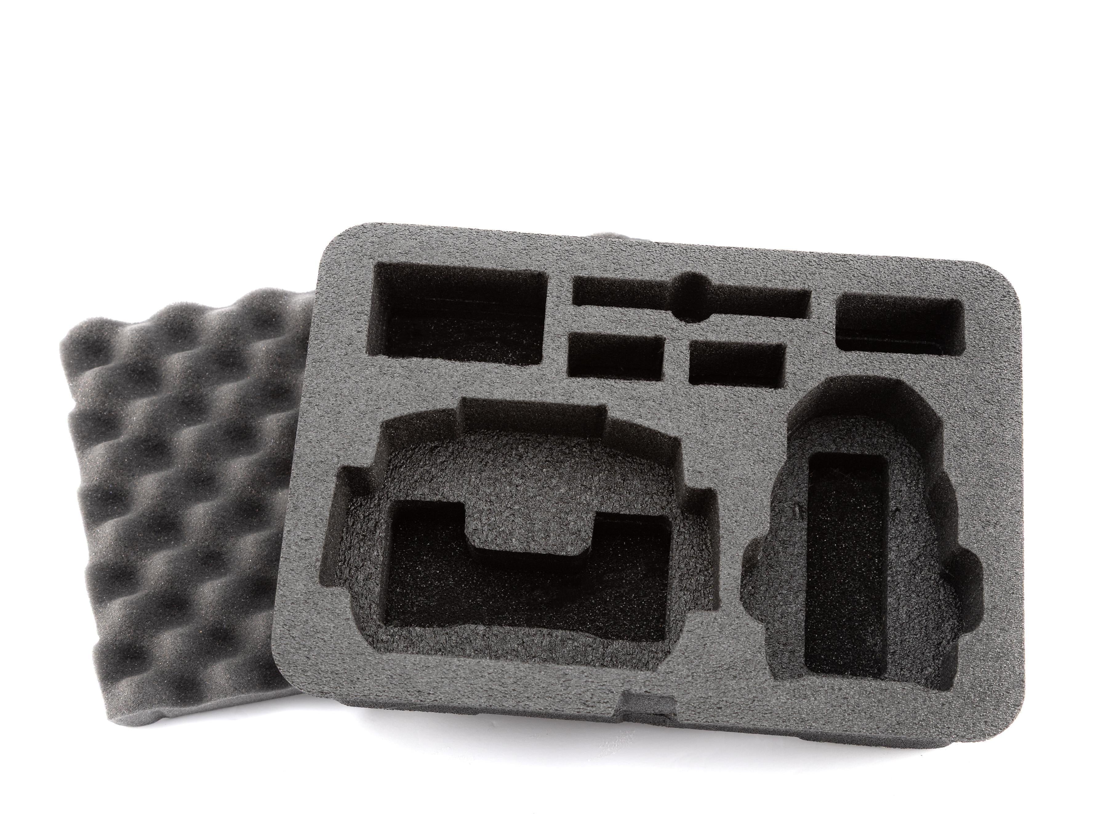 Gray foam packaging tray with cutouts on a white background