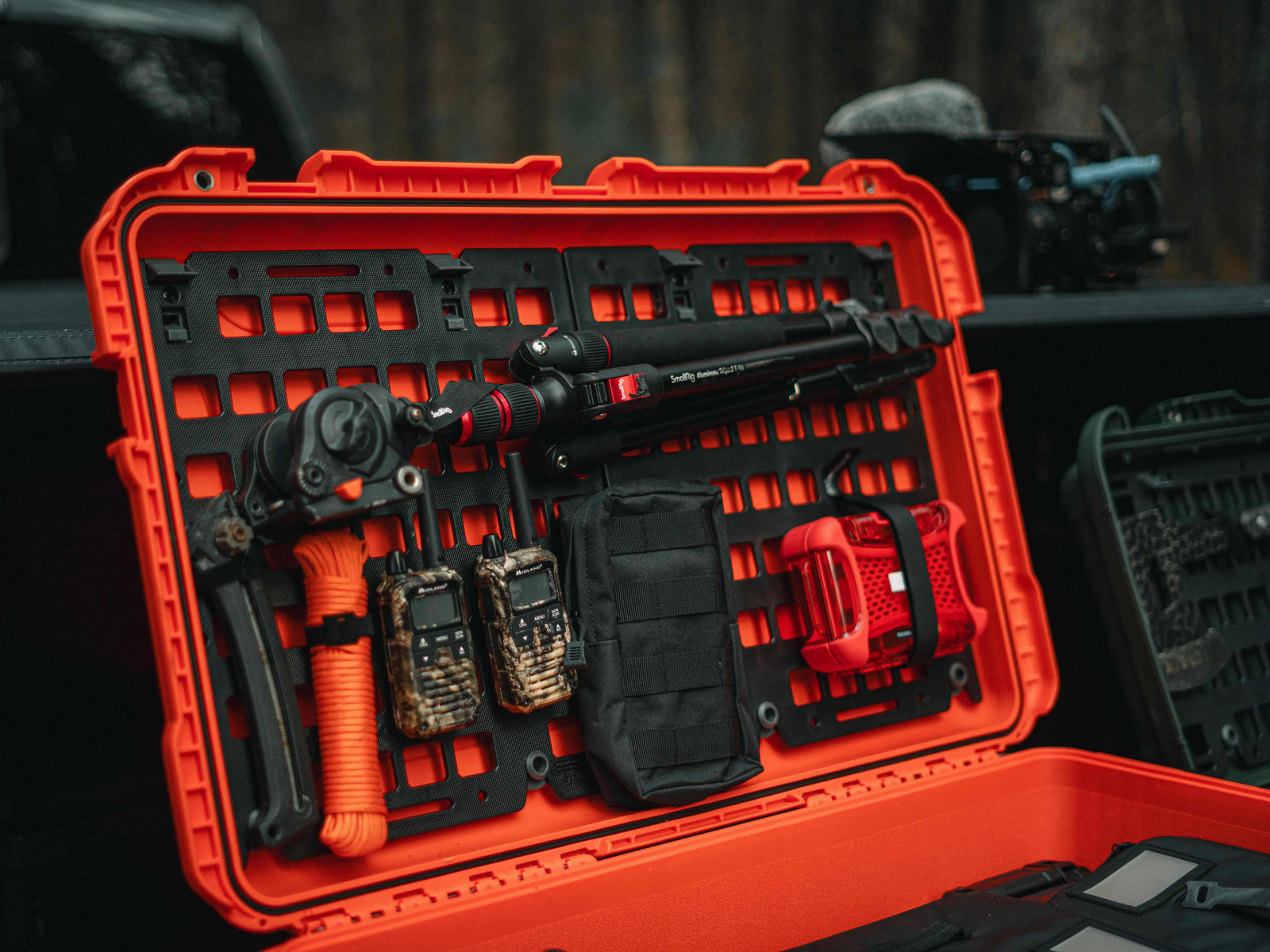 Orange tool case with tools and equipment on a blurred outdoor background