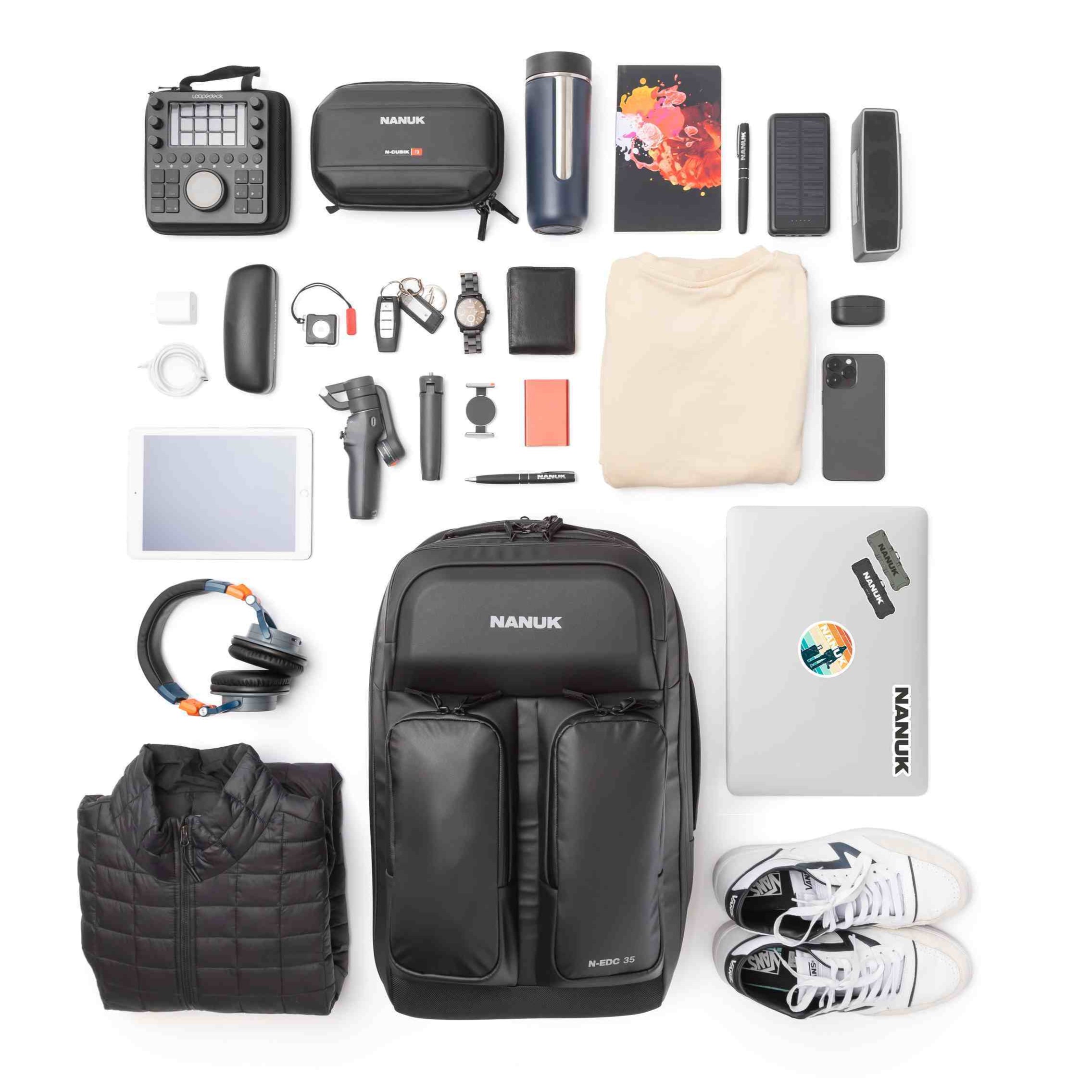 Collection of travel or adventure gear including a backpack, shoes, and electronic devices on a white background.