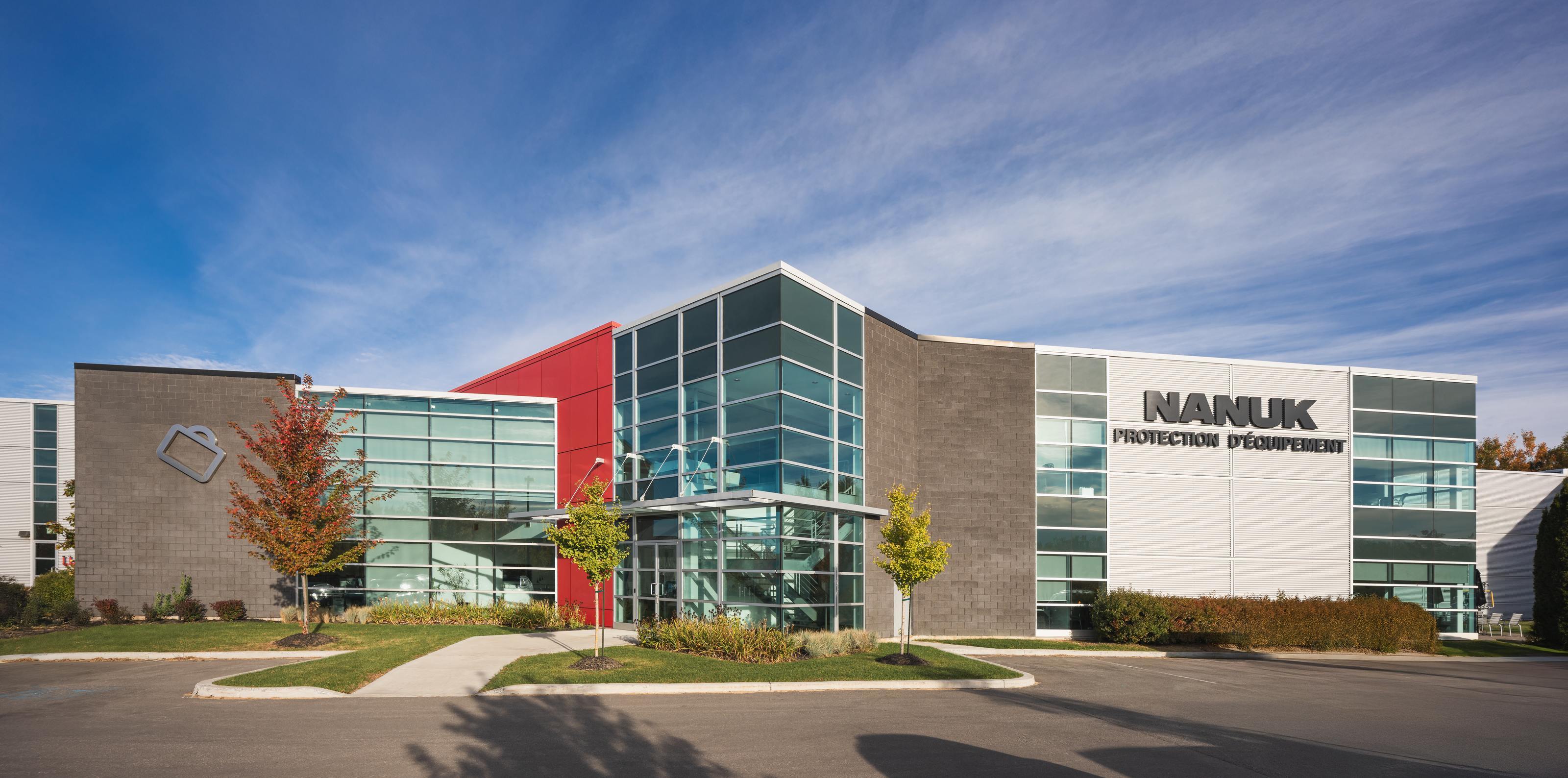 Modern building with 'Nanuk' branding under a clear blue sky