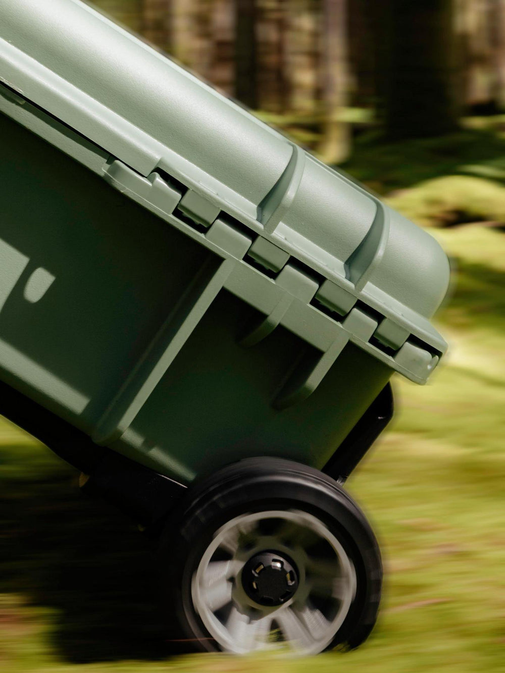 Green wheelbarrow on a grassy field