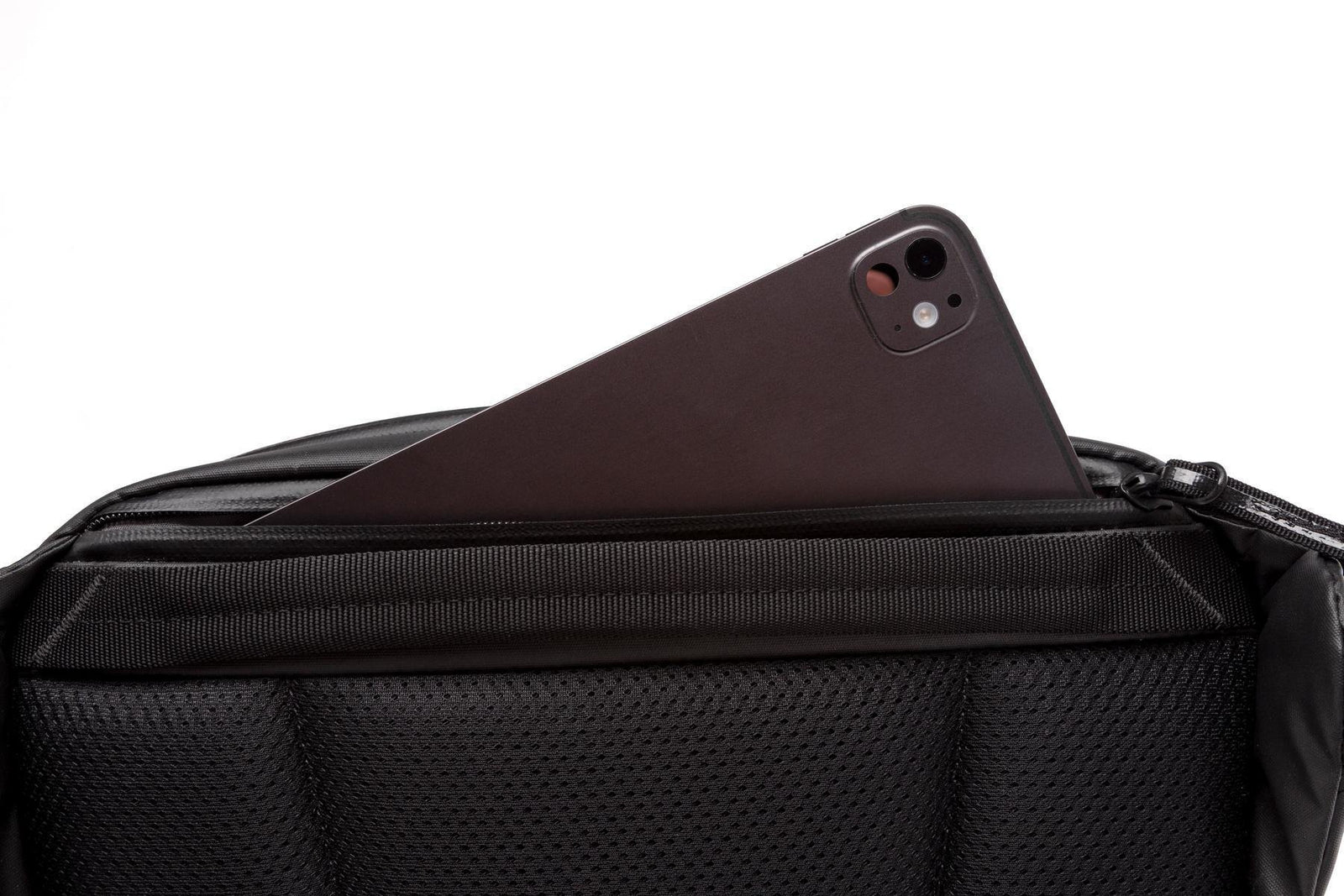 A close-up of a black mesh and fabric bag with a dark brown smartphone partially tucked into the top zipper compartment, shown against a plain white background.