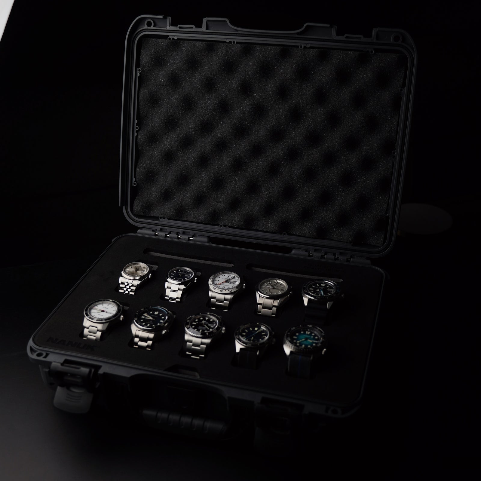 Black case with multiple watches on a dark background