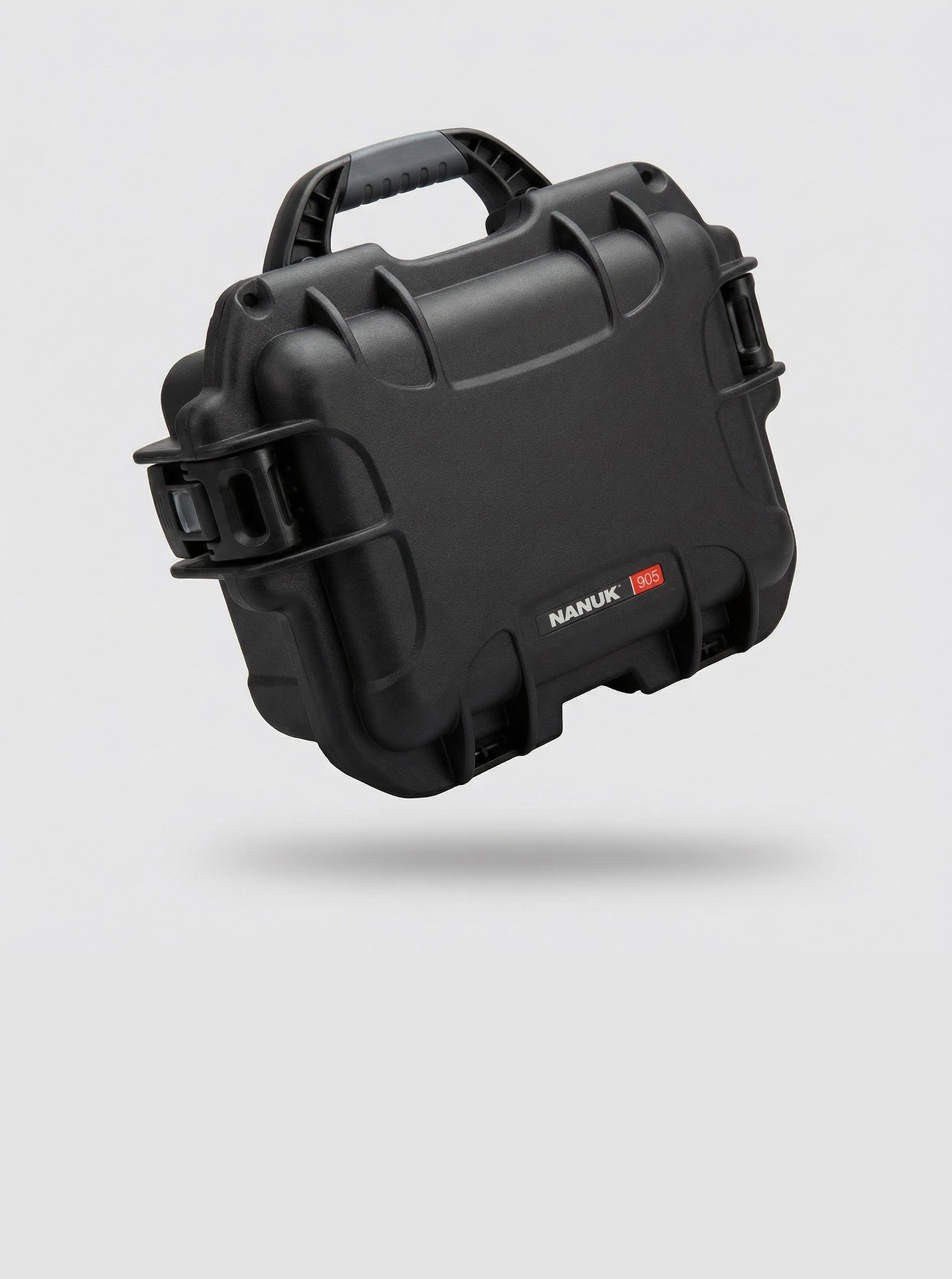 A black Nanuk 905 hard case, part of the Nanuk bags and cases line, floats at an angle on a clean white background, highlighting its textured surface, handle, and latches.