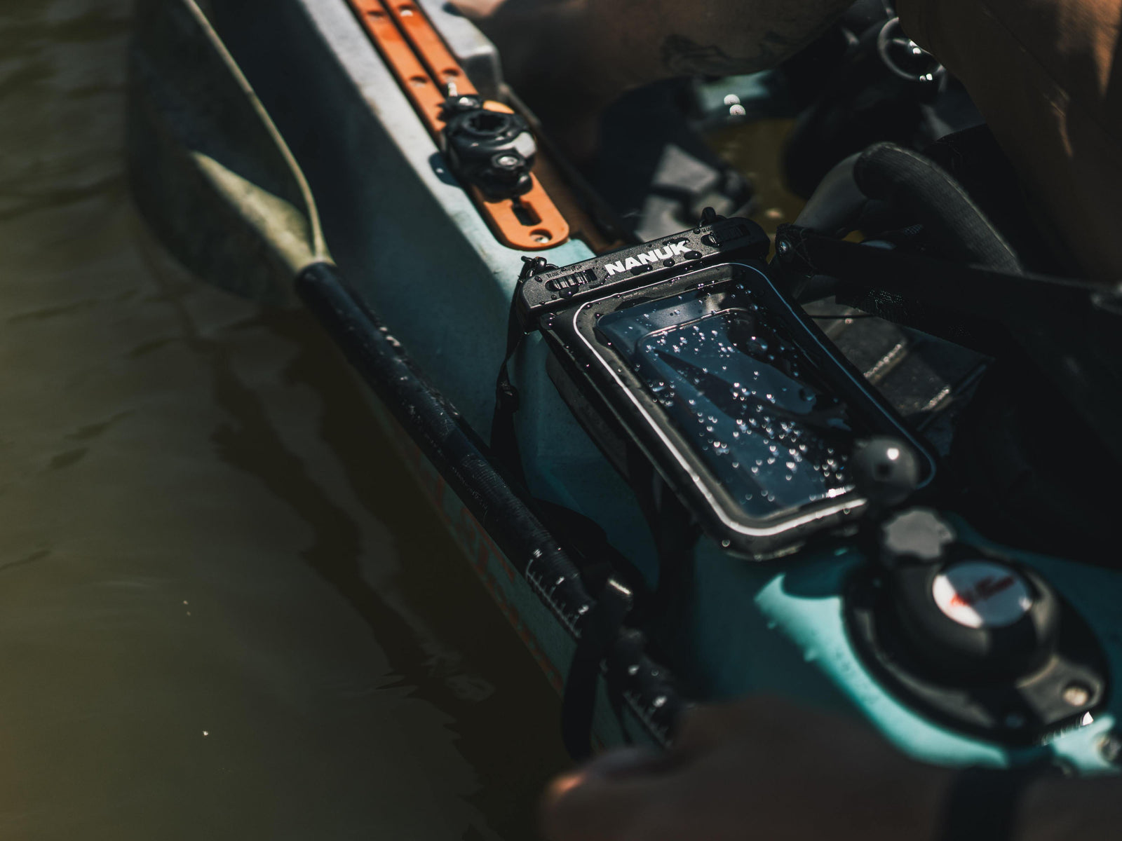 Close-up of a kayak with a fish finder attached on a body of water.